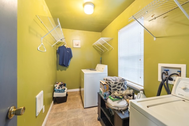 laundry room with separate washer and dryer and light tile patterned floors