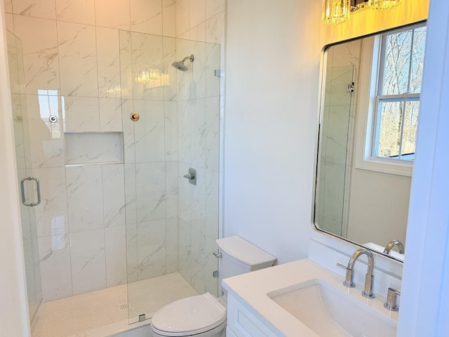 bathroom with vanity, toilet, and an enclosed shower