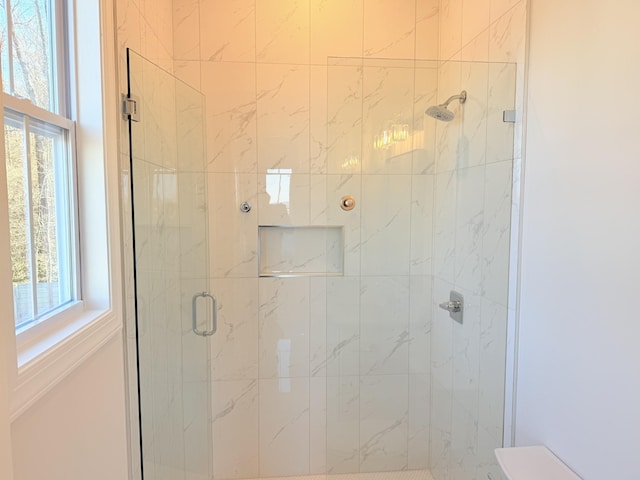 bathroom featuring a shower with shower door