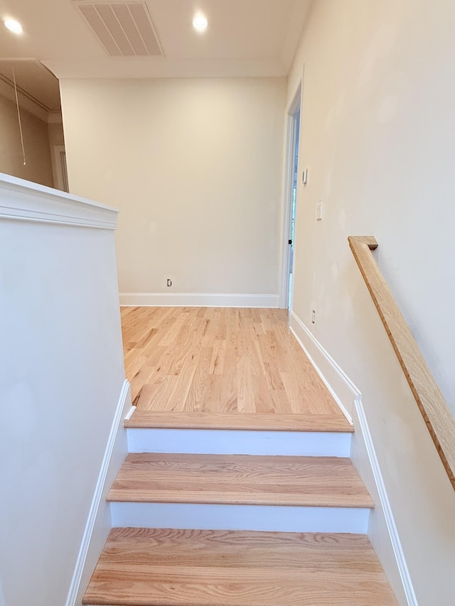 stairs with wood-type flooring