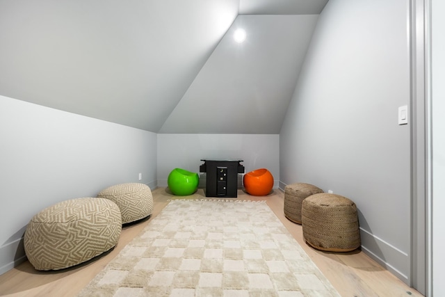 interior space with vaulted ceiling and light hardwood / wood-style flooring