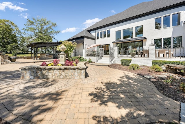 back of property featuring a gazebo