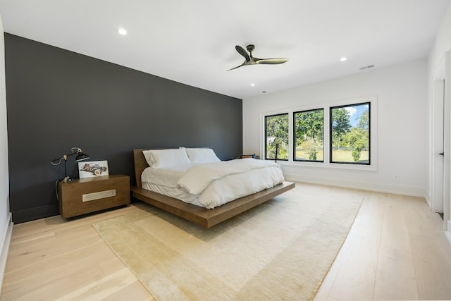 bedroom with ceiling fan and light wood-type flooring