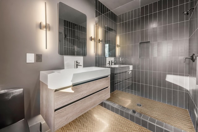 bathroom featuring vanity and tiled shower