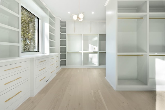 walk in closet featuring light hardwood / wood-style flooring