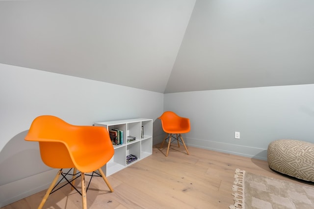 living area with lofted ceiling and light wood-type flooring