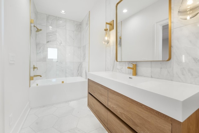 bathroom with tiled shower / bath and vanity