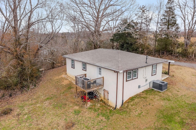 view of home's exterior featuring a yard, central AC, and a deck