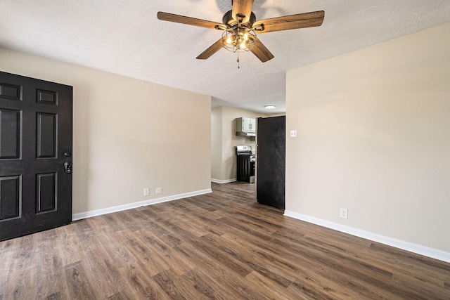 interior space with ceiling fan, dark wood-type flooring, and a textured ceiling