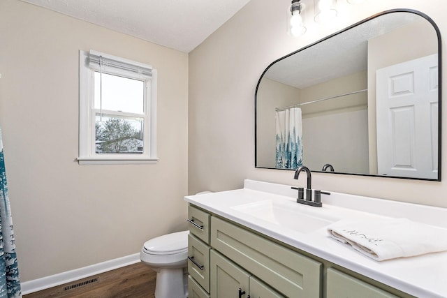 bathroom with hardwood / wood-style flooring, vanity, toilet, and a shower with curtain