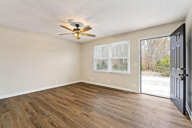 empty room with hardwood / wood-style flooring, a textured ceiling, and ceiling fan