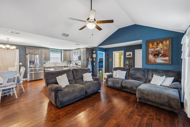 living room with dark wood-type flooring, lofted ceiling, sink, and ceiling fan with notable chandelier