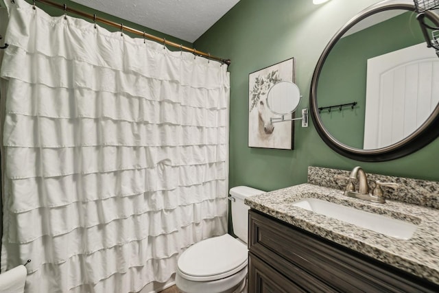 bathroom featuring vanity, a shower with curtain, toilet, and a textured ceiling