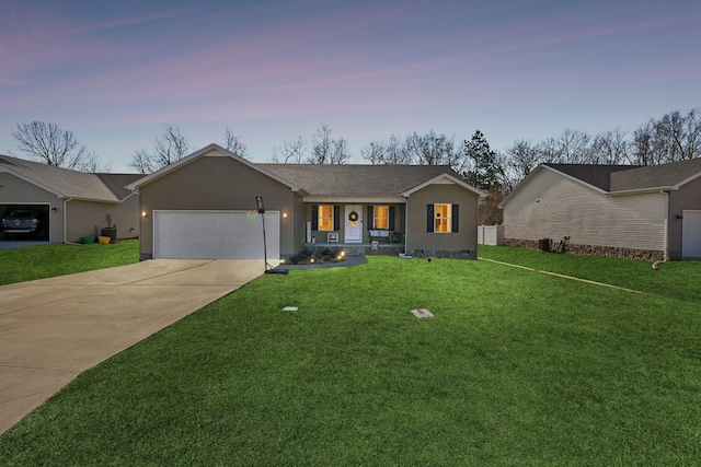 single story home with a garage, a lawn, and a porch