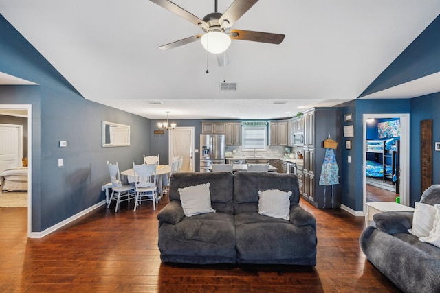 living room featuring lofted ceiling, ceiling fan with notable chandelier, and dark hardwood / wood-style flooring