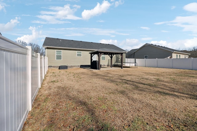 back of property featuring a gazebo, a yard, and central AC unit