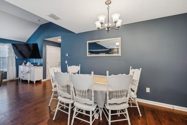 dining area featuring an inviting chandelier, dark hardwood / wood-style flooring, and vaulted ceiling