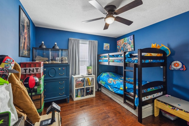 bedroom with dark wood-type flooring, ceiling fan, and a textured ceiling