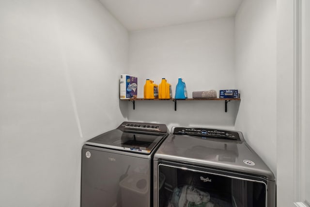 clothes washing area with washer and clothes dryer