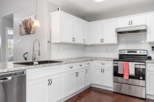 kitchen featuring white cabinetry, stainless steel appliances, sink, and hanging light fixtures