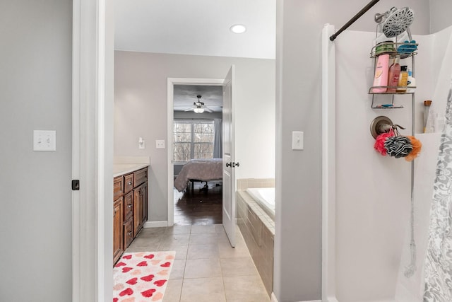 bathroom featuring vanity, plus walk in shower, and tile patterned flooring