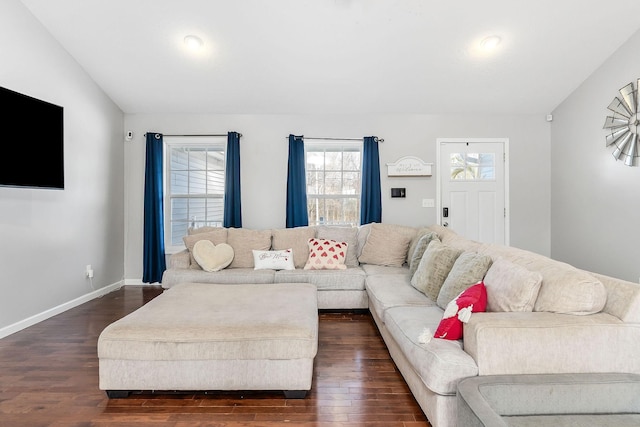 living room featuring dark hardwood / wood-style flooring and vaulted ceiling