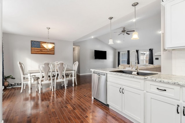 kitchen with lofted ceiling, sink, dishwasher, white cabinetry, and hanging light fixtures