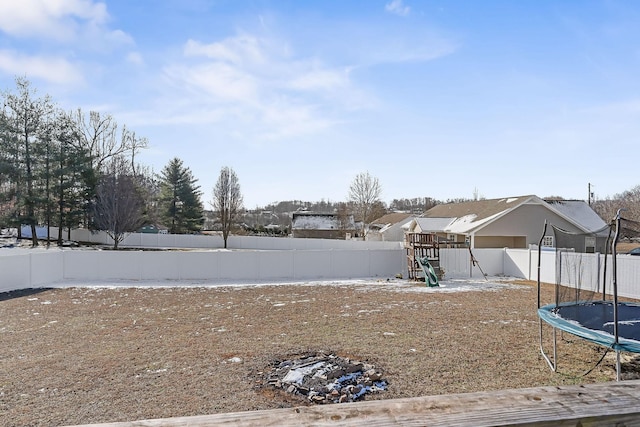 view of yard featuring a playground and a trampoline