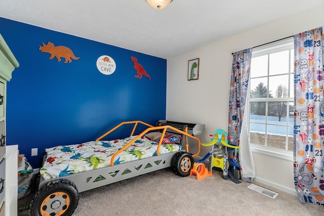 bedroom with multiple windows and carpet