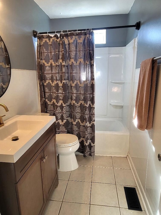 full bathroom featuring vanity, shower / bathtub combination with curtain, tile patterned floors, and toilet