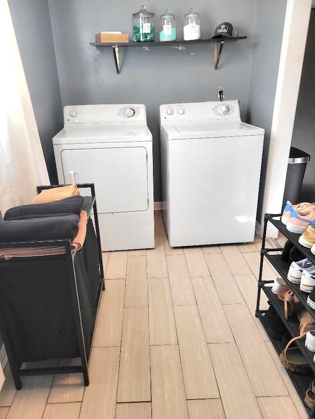 clothes washing area with washing machine and clothes dryer