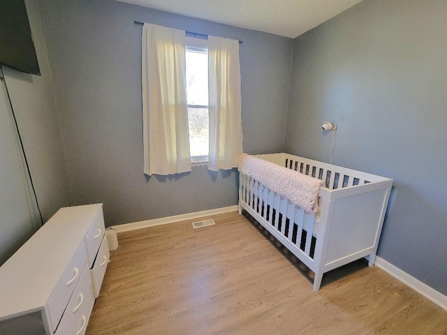 bedroom with light hardwood / wood-style floors