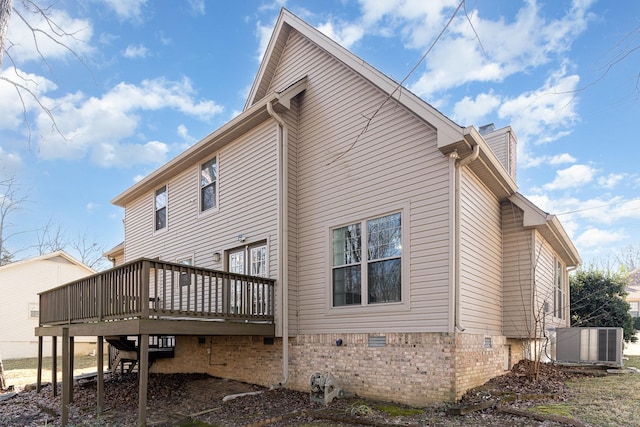 rear view of property featuring a wooden deck and central air condition unit