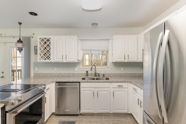 kitchen featuring sink, white cabinets, and appliances with stainless steel finishes