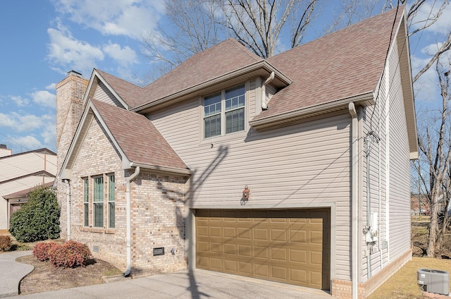 view of front of house featuring a garage and central air condition unit