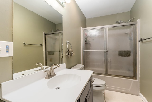 full bathroom featuring vanity, combined bath / shower with glass door, and toilet