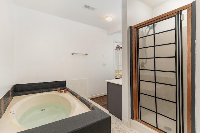 bathroom with vanity and a bath