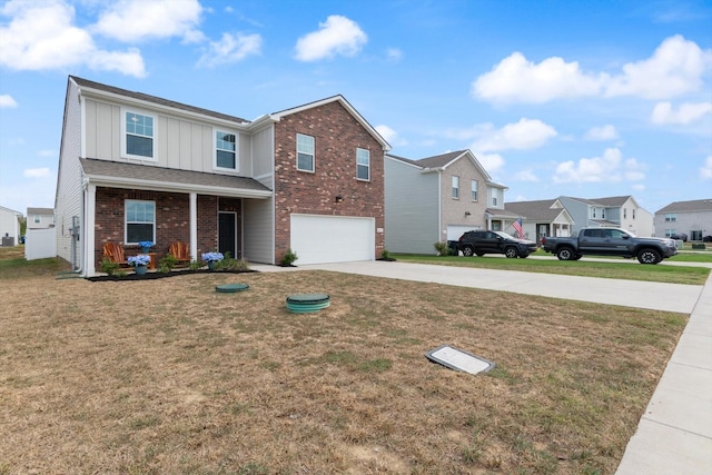 view of front of home featuring a porch, a garage, and a front yard