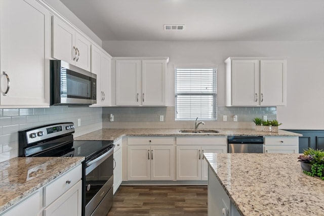 kitchen featuring sink, dark wood-type flooring, stainless steel appliances, and white cabinets