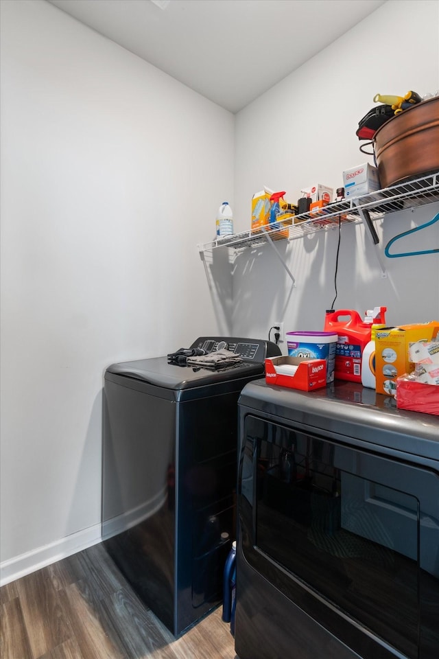 laundry room featuring separate washer and dryer and hardwood / wood-style floors