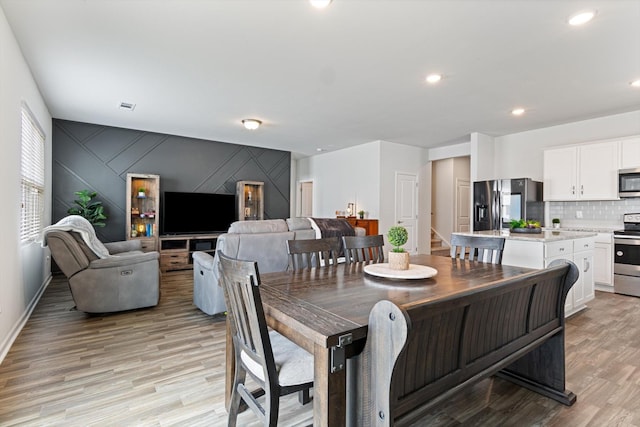 dining room with light hardwood / wood-style flooring