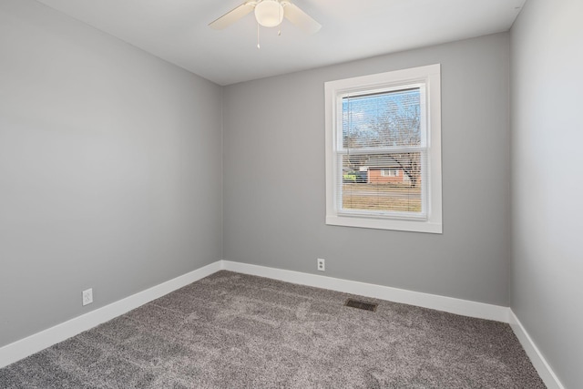 carpeted spare room featuring ceiling fan