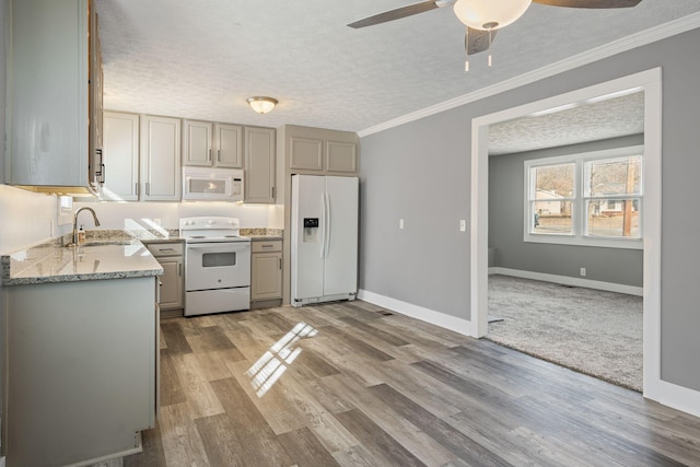 kitchen with white appliances, gray cabinets, sink, and a textured ceiling