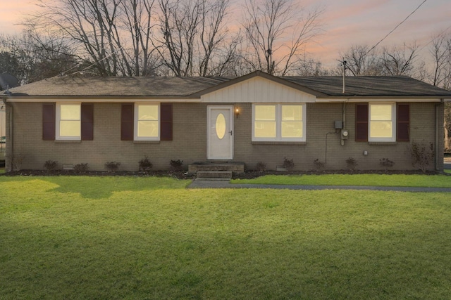 ranch-style home featuring a yard