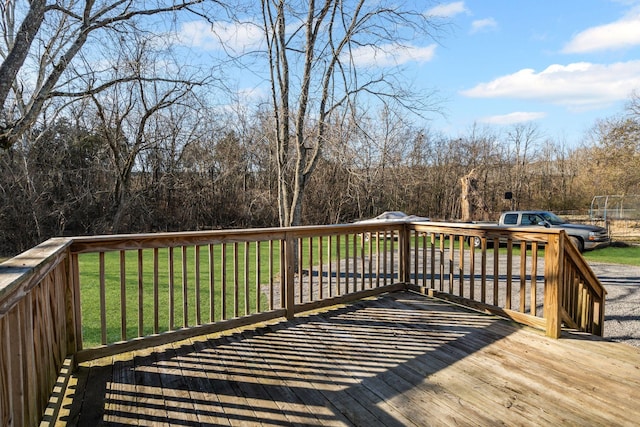 wooden terrace featuring a yard