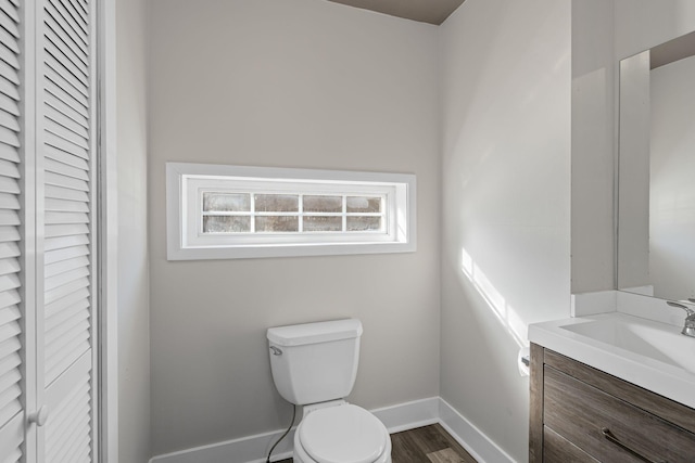 bathroom featuring hardwood / wood-style flooring, vanity, and toilet