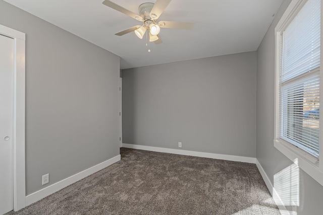 carpeted spare room with ceiling fan