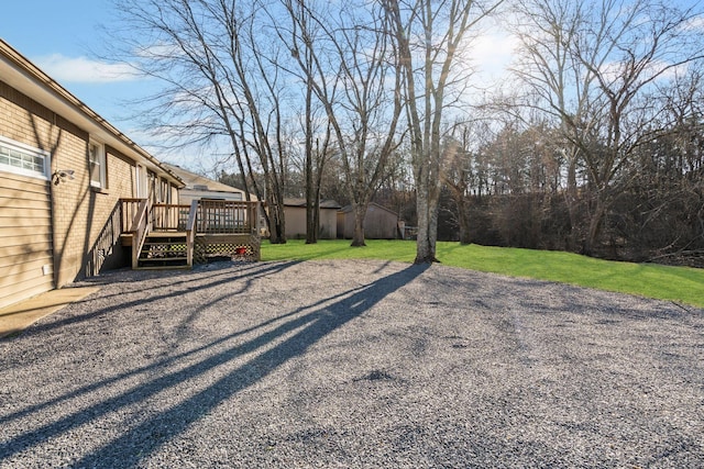 view of yard with a wooden deck