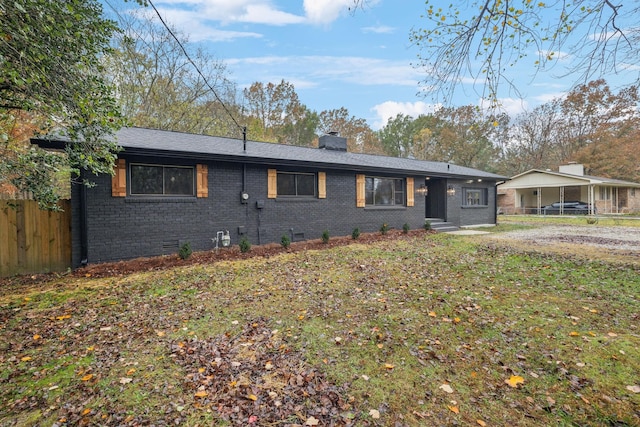 ranch-style house with a front lawn and a carport