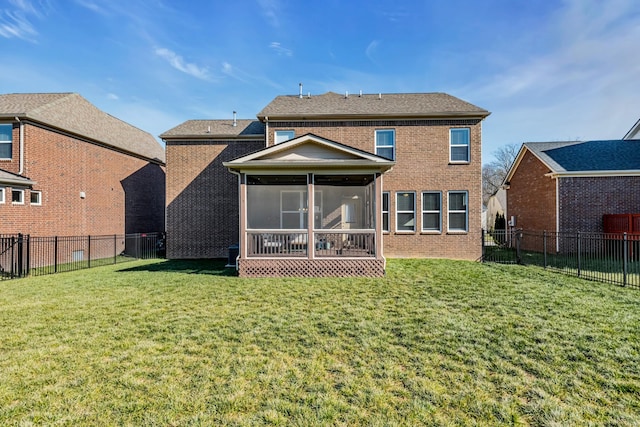 back of property featuring a lawn and a sunroom